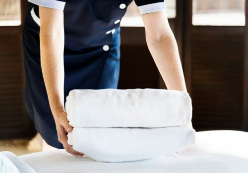 housekeeper-cleaning-hotel-room_53876-146539